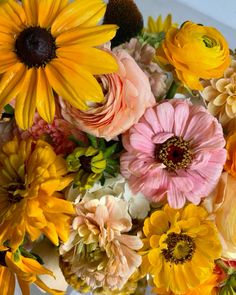 a vase filled with lots of different colored flowers