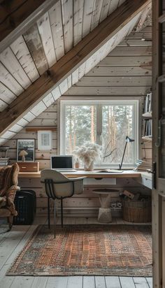 an attic home office with wooden walls and flooring, along with a rug on the floor