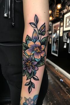 a woman with a flower tattoo on her arm