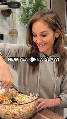 a woman cutting up food in a bowl on top of a wooden table with the caption new year, new slaw