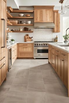 a large kitchen with wooden cabinets and white counter tops, along with beige flooring