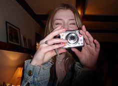 a woman taking a photo with her camera