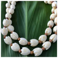 "This necklace is made with 12x10mm (large) ivory colored lucite vintage pīkake beads and accented with 4mm ʻiliahi (sandalwood) beads. Necklace length measures approximately 30\"." White Spiritual Jewelry With Wooden Beads, Spiritual White Jewelry With Wooden Beads, Traditional White Carved Necklaces, Vintage White Oval Beads Necklaces, Vintage White Oval Bead Necklaces, Vintage White Beaded Necklace With Wooden Beads, Vintage White Oval Beaded Necklaces, Vintage White Necklaces With Oval Beads, Traditional White Single Strand Beaded Necklace