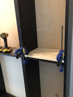 two tools are sitting on top of a shelf