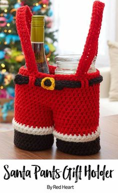 a crocheted santa pants gift holder with wine bottle in it