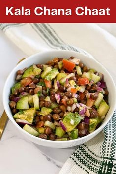 a white bowl filled with black eyed peas, cucumber and red onion salad