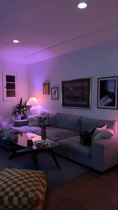 a living room filled with furniture and purple lighting