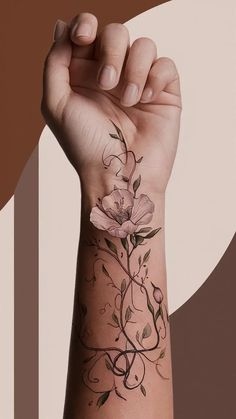 a woman's arm with a flower tattoo on the wrist and an abstract background