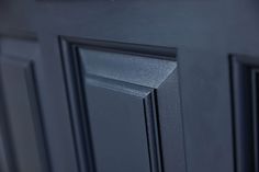 a close up view of the door handles on a black cabinet