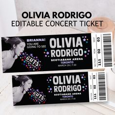 two tickets for an event with the name olvia rodrigo on them and a roll of toilet paper next to it