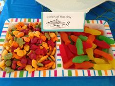 there are many different types of gummy bears on the table with a sign that says catch of the day