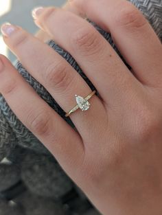 a woman's hand with a diamond ring on it