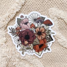 a sticker with an image of flowers and mushrooms on it's back side