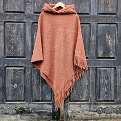 Wool blanket poncho  - cape  with fringes One size fits all  -  men or women.  Available with hood or without hood 100% wool CARE: Hand-wash and hang to dry, light iron if needed, or dry clean. MEASURES:  Available in two sizes: SHORTER Length at the front of the neckline to the bottom is ~87 cm/34 inches, the shoulder length is ~54cm/21 inches, LONGER Length at the front of the neckline to the bottom is ~115 cm/45 inches, the shoulder length is ~80cm/31 inches, Model in pictures is 170cm high a Hooded Wool Poncho For Fall, Oversized Fringe Cape For Winter, Fringe Cape Poncho For Winter, Winter Fringe Cape Outerwear, Winter Shawl Cape With Fringe, Winter Fringe Cape Shawl, Winter Fringe Cape Poncho, Red Bohemian Hooded Poncho, Cozy Winter Poncho With Fringe