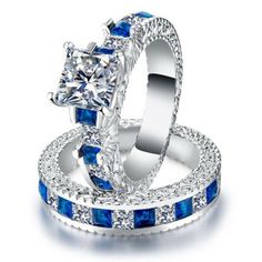 two wedding rings with blue and white diamonds