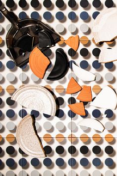 an array of different shapes and sizes of objects on a polka dot tablecloth with circles