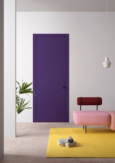 a living room with a purple door and yellow rug on the floor in front of it