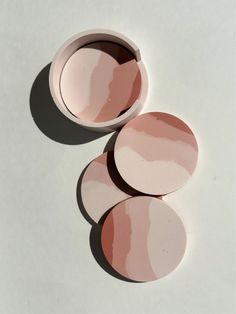 three pink and white plates sitting on top of each other