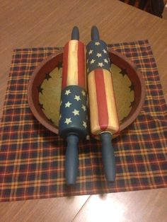 two wooden american flags are in a bowl