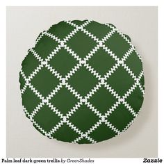 a green and white pattern on a round cushion