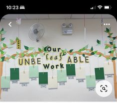 a classroom wall decorated with paper cutouts and hanging from the ceiling, which reads our unefeaff able work