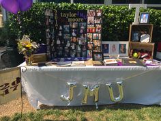 a table that has some pictures on it with balloons in the background and photos hanging from them