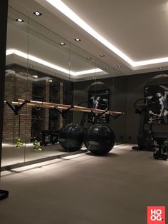 a gym with exercise equipment and mirrors