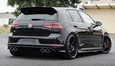 the rear end of a black vw golf gtr parked in a parking lot