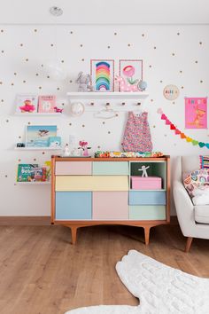 a child's room decorated in pastel colors with polka dots on the wall