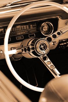 the steering wheel and dashboard of an old car