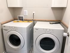 two washers and dryer in a small room