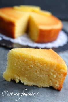 a piece of cake sitting on top of a table next to a plate with a slice cut out of it