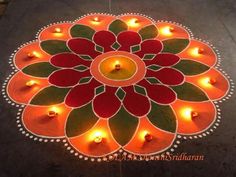 a decorated floor with lit candles in the shape of a flower