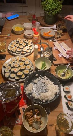 the table is full of sushi and other foods