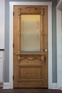 a wooden door with a mirror on top of it in a room that has blue walls and white trim