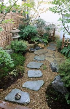 a stone path in the middle of a garden