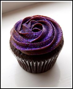 there is a cupcake with purple frosting on it