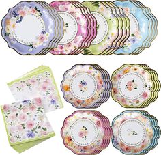 a bunch of plates and napkins that have flowers on the front, one has a flowered design