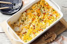 a casserole dish with chicken, cheese and vegetables