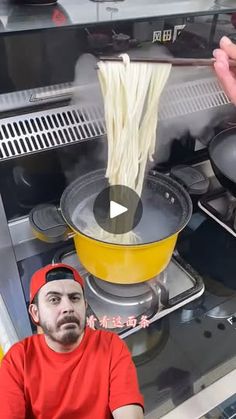 a man is cooking noodles in a pot on the stove