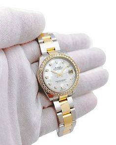 Ladies Rolex DateJust 31mm Midsize Two Tone 18K Yellow Gold / Stainless Steel Watch with Mother of Pearl Diamond Dial and Diamond Bezel. Pre-Owned SN# 9W8***** Year: 2018. Brand: Rolex. Dial: Diamond. Bezel: Diamond. Crystal: Sapphire. Gender: Women's. Condition: Excellent. Case Dimensions: 31mm. Model Number: 178383. Dial Color: Mother of Pearl. Date on Card: May 03, 2018. Movement: Self-Winding (Automatic). Metal Type: 18K Yellow Gold / Stainless Steel. Bracelet / Strap: 18K Yellow Gold / Stainless Steel. Box / Certificate: Includes Rolex Box / Rolex Card. Service Warranty: Includes One (1) Service Warranty. Gold Diamond Chronometer Watch, White Diamond Watch With Chronometer As Gift, Yellow Gold Diamond Watch For Everyday Luxury, Yellow Gold Diamond Watch As Gift, Yellow Gold Diamond Watch With Chronometer, Yellow Gold Diamond Watch For Formal Occasions, Diamond Jewelry And Watches As A Gift, Zenith Watches, Coach Watch