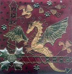 a red and gold dragon with stars on it's side, in the middle of an ornate design