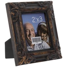 an old wooden frame with a bar code on the front and two people behind it