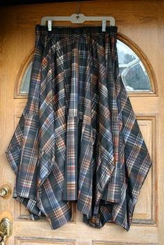 a plaid skirt hanging on the front door to dry off from the sun or wind