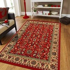 a large red rug in the middle of a living room