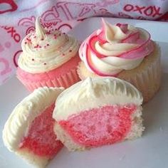 three cupcakes with white and pink frosting