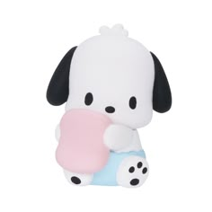 a white and black dog holding a pink object