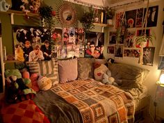 a bed room with a neatly made bed and many pictures on the wall above it