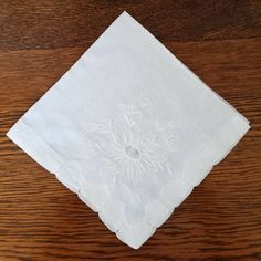 "Here is a beautiful vintage pure white hankie.  It is made of sheer, soft linen fabric and is all hand sewn.  The hanky features lovely white-on-white embroidered flowers in each corner.  The center of each flower is done in fine honeycomb work.  The edges of the handkerchief have skillfully done drawn-work. The hanky is a nice size, measuring approximately 14\" X 14\".  It is in very good to excellent condition with no damage, stains or odors.  It would make a beautiful wedding handkerchief fo Cheap White Retro Handkerchiefs, Wedding Handkerchief, Pure White, Embroidered Flowers, White Linen, Hand Sewn, Honeycomb, Linen Fabric, White Vintage