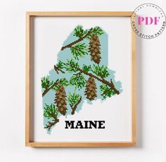 a cross stitch pattern with pine cones and the word maine